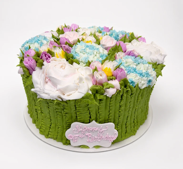 Floral cake with "Happy Birthday" plaque.